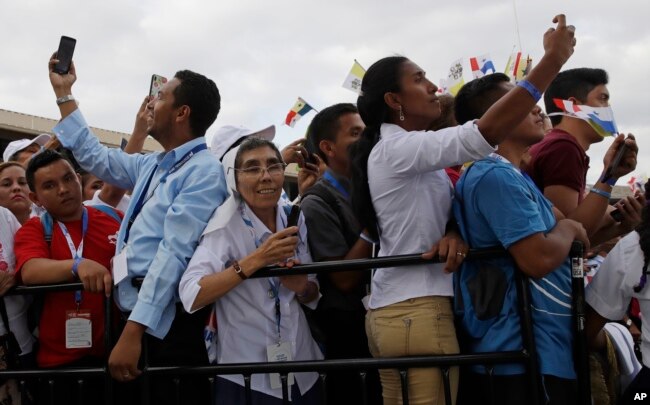 People take pictures as Pope Francis arrives at Tocumen international airport in Panama City, Jan. 23, 2019.