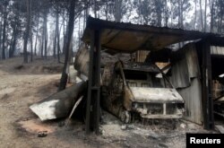 A burned van is seen following a forest fire in Barraca da Boavista, outside Pedrogao Grande, Portugal, June 19, 2017.