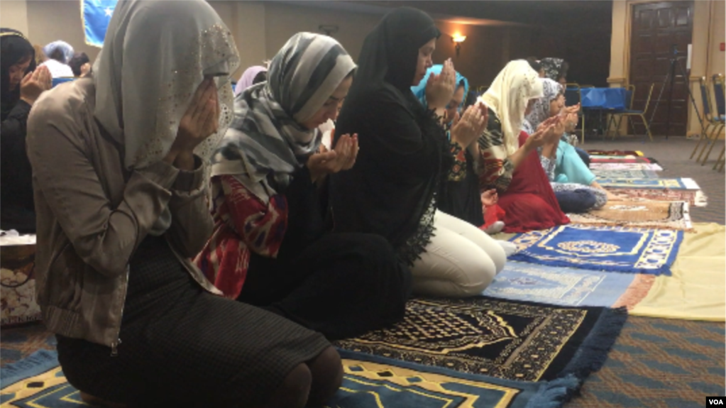 Uighur Muslim women pray as part of Eid festivities in Falls Church, Virginia, Aug. 21, 2018. (B. Gallo/VOA) 