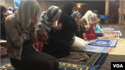 Uighur Muslim women pray as part of Eid festivities in Falls Church, Virginia, Aug. 21, 2018. (B. Gallo/VOA) 
