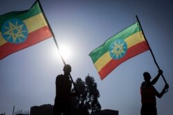 New military recruits who are joining the Ethiopian National Defense Force hold Ethiopian national flags during the send-off ceremony in Addis Ababa, Nov. 24, 2021.