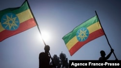 New military recruits who are joining the Ethiopian National Defense Force hold Ethiopian national flags during the send-off ceremony in Addis Ababa, Nov. 24, 2021.