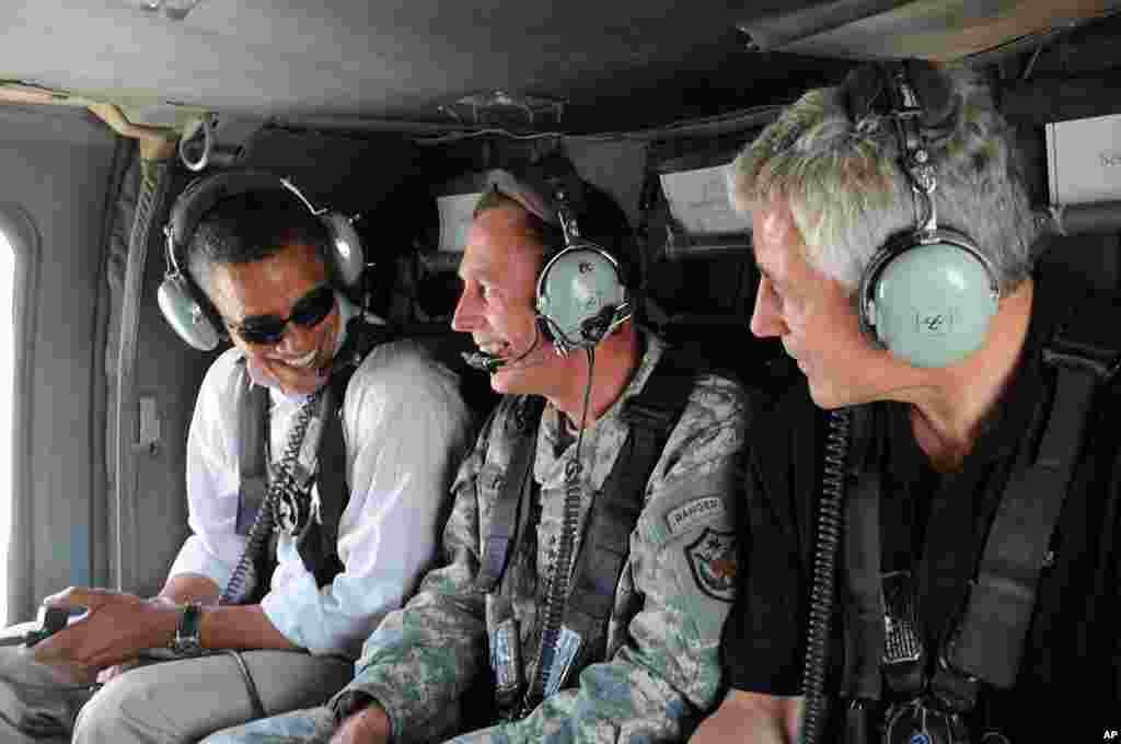In this photo released by the U.S. army, then Democratic presidential candidate Barack Obama, David Petraeus, and Chuck Hagel, ride in a helicopter, Baghdad, Iraq, July 21, 2008.