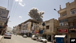 Smoke rises from a house of former Yemeni President Ali Abdullah Saleh after a Saudi-led airstrike in Sanaa, Yemen, Sunday, May 10, 2015.