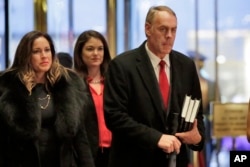 Rep. Ryan Zinke, right, R-Mont., arrives in Trump Tower, in New York, Dec. 12, 2016.