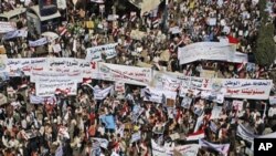 Supporters of Yemeni President Ali Abdullah Saleh hold banners and raise his portraits during a rally in support of Saleh and his government in Sanaa,Yemen, Thursday, Feb. 3, 2011.