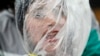 A Nepalese activist stands wrapped in a plastic sheet with a rope tied around her neck as a mark of protest against air pollution on Earth Day in Kathmandu, Nepal.