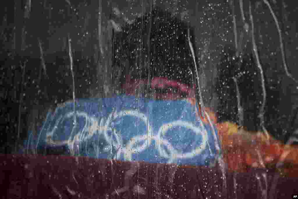 Raindrops roll down on the vinyl window of a tent at the Rosa Khutor Extreme Park, at the 2014 Winter Olympics, Feb. 18, 2014.