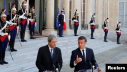 FILE - French President Emmanuel Macron meets Italian Prime Minister Paolo Gentiloni at the Elysee Palace in Paris, France, May 21, 2017. 