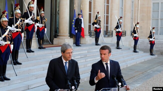 FILE - French President Emmanuel Macron meets Italian Prime Minister Paolo Gentiloni at the Elysee Palace in Paris, France, May 21, 2017. 