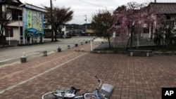 A bicycle is left near a station in the part of Minamisoma town that is inside the 20-kilometer evacuation zone in Fukushima Prefecture, Japan, April 21, 2011.