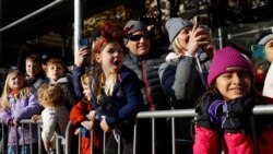 Spectators react as they watch the 95th Macy's Thanksgiving Day Parade in Manhattan, New York City, Nov. 25, 2021.