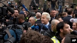 Firebrand int-islam lawmaker Geert Wilders, center, talks to media during his election campaign stop in Spijkenisse, near Rotterdam, Netherlands, Feb. 18, 2017.
