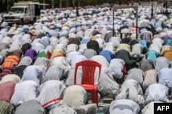 Sudanese protesters perform a Friday Muslim prayer during a sit-in outside the army headquarters in the capital Khartoum, April 26, 2019.