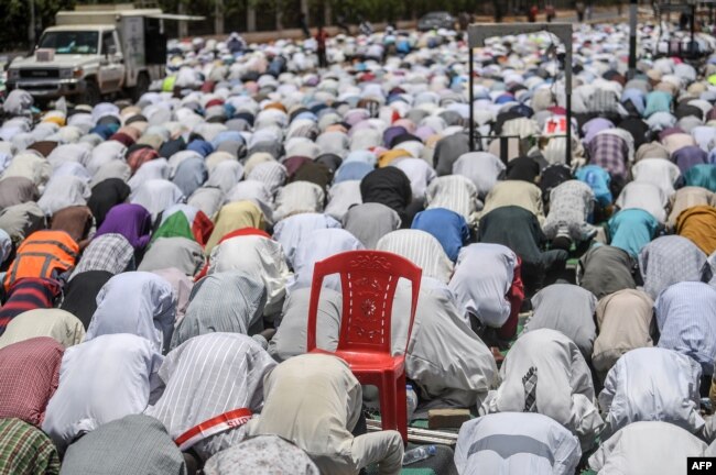 Sudanese protesters perform a Friday Muslim prayer during a sit-in outside the army headquarters in the capital Khartoum, April 26, 2019.