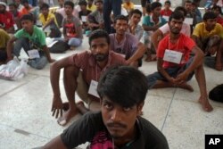Rohingya migrants sit on the floor at the authority's district office of Rattaphum, Songkla province, southern Thailand, as they were found abandoned in Khao Kaew mountain near the Thai-Malaysia border, May 9, 2015.