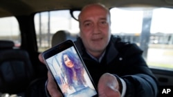 Motaz Alafandi of Syria shows a photo he keeps on his smartphone of his daughter Yara, 18, who lives in Montreal, Jan. 27, 2017, in Garland, Texas. Alafandi, a 49-year-old Syrian lives in Dallas while seeking asylum with his wife and three youngest children, ages 14, 11 and 5. "I wish that Mr. President (Trump) can help in stopping the war in Syria," said Alafandi, who said he loves the U.S. and the American people but does hope to return one day to his homeland.