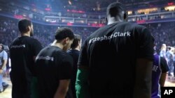 Boston Celtics players wear T-shirts in memory of Stephon Clark before the start of an NBA basketball game against the Sacramento Kings in Sacramento, Calif., Sunday, March 25, 2018.