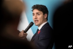 FILE - Canadian Prime Minister Justin Trudeau speaks at the Paris Peace Forum as part of the commemoration ceremony for Armistice Day, in Paris, Nov. 11, 2018.