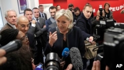 FILE - French far-right leader and presidential candidate Marine le Pen answers reporters questions at her campaign headquarters, Nov.16, 2016, in Paris. 