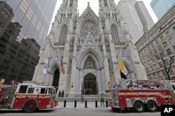 While firemen conduct an inspection, fire trucks are parked in front of St. Patrick's Cathedral in New York, April 18, 2019.