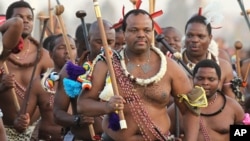 FILE - Swaziland's King Mswati III, front in traditional garb, dances during a Reed Dance in Mbabane, Swaziland, Sept. 3, 2012. Mswati, considered Africa's last absolute autocrat, will chair the SADC during the coming year.
