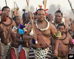 FILE - Swaziland's King Mswati III, front in traditional garb, dances during a Reed Dance in Mbabane, Swaziland, Sept. 3, 2012.