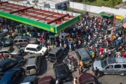 FILE - Drivers wait in hopes of filling their tanks at one of the few remaining open gas stations in Port-au-Prince, Haiti, Oct. 31, 2021.