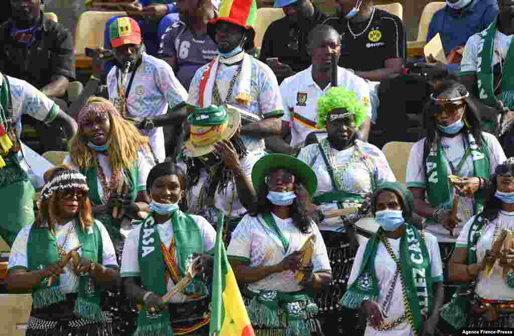 Football fans watch the football match between Senegal and Zimbabwe.