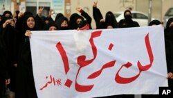 Bahraini protesters carry a banner reading, "We will not bow! #alNimr," during a demonstration against Saudi Arabia's execution of Shiite cleric Sheikh Nimr al-Nimr, in Daih, Bahrain, Jan. 2, 2016.