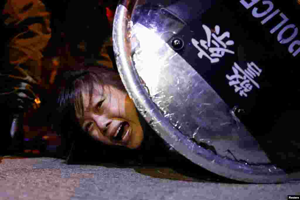 An anti-extradition bill protester is detained by riot police during a protest outside Mong Kok police station.