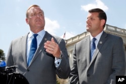 FILE - Rep. Jeff Denham, R-Calif., left, speaks next to Rep. David Valadao, R-Calif., during a news conference, May 9, 2018, on Capitol Hill in Washington. The Republican incumbents were swept out of office in 2018 after a tally of late-arriving ballots.