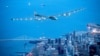 Solar Plane Flies Over Statue of Liberty