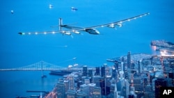 FILE - Solar Impulse 2 flies over San Francisco, April 23, 2016. The solar-powered airplane has left Pennsylvania for New York City on the latest leg of its globe-circling voyage. 