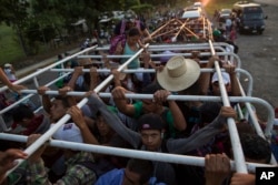 Migrants travel on a cattle truck, as a thousands-strong caravan of Central American migrants slowly makes its way toward the U.S. border, between Pijijiapan and Arriaga, Mexico, Oct. 26, 2018.
