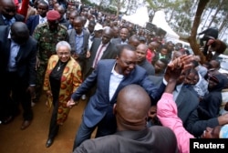 Kenya's President Uhuru Kenyatta is greeted by supporters after casting his vote in the Kenya election in his hometown of Gatundu in Kiambu county, Kenya, Aug. 8, 2017.