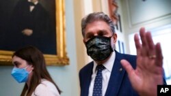 Sen. Joe Manchin, D-W.Va., walks past reporters after attending a lengthy Democratic Caucus meeting as the Senate continues to grapple with end-of-year tasks at the Capitol in Washington, Dec. 16, 2021.