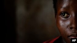 FILE - A pregnant 15-year-old girl who was the victim of statutory rape, sits in the house where she stays in Masaka, Uganda, May 30, 2017. UNICEF says 35 percent of Ugandan females and 17 percent of males have been sexually abused.