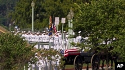 A horse-drawn caisson carries the casket containing the remains of Sen. John McCain, R-Ariz., to his burial sight at the United States Naval Academy Cemetery in Annapolis Md., Sunday, Sept. 2, 2018. McCain died Aug. 25 from brain cancer at age 81.