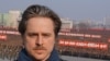 Norwegian Director Morten Traavik in front of a North Korean rally on Pyongyang's Kim Il Sung Square on March 7, 2013. The rally was in support of the government's announced cancellation of the 1953 Korean War cease-fire. in on March 7, 2013. 