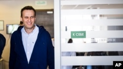 Russian opposition leader Alexei Navalny smiles as he arrives at his office in Moscow, Russia, July 7, 2017. 