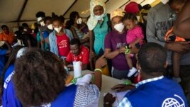 Haitians who were deported from the U.S. border with Mexico are attended by members of the IOM UN Migration organization before they get tested for COVID-19 at Toussaint Louverture International Airport in Port-au-Prince, Haiti, Monday, Sept. 20, 2021. (AP)