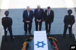 ອະດີດປະທານາທິບໍດີ Bill Clinton (ກາງ) ຕິດຕາມໂດຍ ປ. ອິສຣາແອລ ທ່ານ Reuven Rivlin (ຊ້າຍ) ແລະທ່ານ Yuli Edelstein ປະທານສະພາຕ່ຳ Knesset ຮວມສະແດງຄວາມເຄົາລົບ ຕໍ່ໜ້າຫີບສົບ ມື້ລາງປະທານາທິບໍດີ Shimon Peres