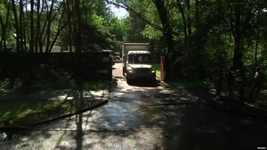 A still image taken from a video footage shows trucks packed with furniture and diplomats' belongings leaving a dacha compound used by U.S. diplomats for recreation, in Serebryany Bor residential area in the west of Moscow, Russia, Aug. 1, 2017.