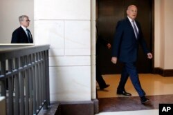 White House Chief of Staff John Kelly, right, arrives for a meeting on the Trump Russia probe, followed by President Trump's lawyer Emmet Flood, left, May 24, 2018, on Capitol Hill in Washington.