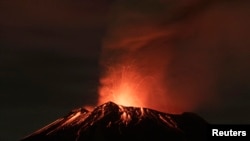 FILE - Smoke rises from the Popocatepetl as it spews incandescent volcanic material on the outskirts of Puebla, Mexico, July 4, 2013. 