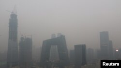FILE - Beijing's landmark buildings are seen during a polluted day in Beijing, China, Nov. 18, 2016. 