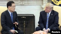 South Korea's national security chief Chung Eui-yong briefs U.S. President Donald Trump at the Oval Office about his visit to North Korea, in Washington, March 8, 2018.