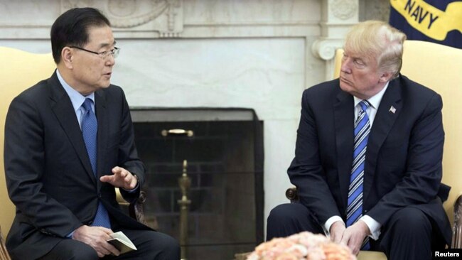 South Korea's national security chief Chung Eui-yong briefs U.S. President Donald Trump at the Oval Office about his visit to North Korea, in Washington, March 8, 2018.