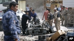 Security forces inspect the scene of a car bomb attack in Basra, 550 kilometers southeast of Baghdad, Iraq, Sunday, Sept. 9, 2012. 